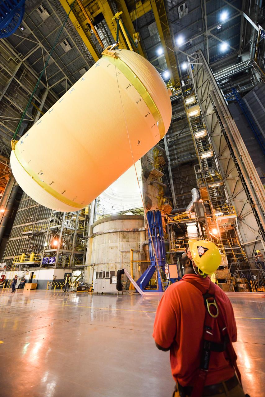 The Space Launch System (SLS) rocket’s liquid oxygen tank structural test article was manufactured and stacked in June 2019 at NASA’s Michoud Assembly Facility in New Orleans. To construct the test article, Boeing technicians at Michoud moved the liquid oxygen tank to the Vertical Assemby Building stacking and integration area. Here, they added simulators to mimic the two structures that connect to the tank, the intertank and the forward skirt.  This structural hardware for the SLS core stage for America’s new deep space rocket is structurally identical to the flight version of the tank. It will be shipped on the Pegasus barge to NASA’s Marshall Space Flight Center in Hunstville, Alabama, where it will undergo a series of tests that simulate the stresses and loads of liftoff and flight. These tests will help ensure designs are adequate for successful SLS missions to the Moon and beyond. The flight liquid oxygen tank along with the liquid hydrogen tank supplies more than 500,000 gallons of propellant to the core stages four RS-25 engines, which produce 2 million pounds of thrust to help send the SLS rocket to space.